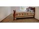 A cozy bedroom features carpeted floors, natural light from a window, and a comfortable-looking quilt at 22739 E Prentice Pl, Aurora, CO 80015