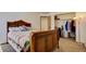 The bedroom offers an inviting atmosphere with carpet, a bed with a unique headboard, and a closet at 22739 E Prentice Pl, Aurora, CO 80015