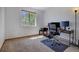 Bedroom with a large window providing natural light and a dedicated workspace with a desk at 22739 E Prentice Pl, Aurora, CO 80015