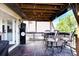 Relaxing covered deck with a grill, tv, and table with chairs, great for outdoor dining and leisure at 22739 E Prentice Pl, Aurora, CO 80015