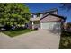 Charming two-story home featuring a brick-accented garage and well-manicured front lawn at 22739 E Prentice Pl, Aurora, CO 80015