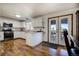 Bright kitchen featuring white cabinetry, stainless steel appliances, hardwood floors, and French doors at 22739 E Prentice Pl, Aurora, CO 80015