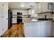 Bright kitchen featuring white cabinetry, stainless steel appliances, and hardwood floors at 22739 E Prentice Pl, Aurora, CO 80015