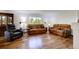 Spacious living room featuring hardwood floors and comfortable leather furnishings at 22739 E Prentice Pl, Aurora, CO 80015