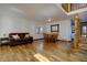 Spacious living room with hardwood floors, a leather couch, and staircase leading to the upper level at 22739 E Prentice Pl, Aurora, CO 80015