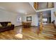 Inviting living room featuring hardwood floors, a cozy couch, and dining area with natural light at 22739 E Prentice Pl, Aurora, CO 80015