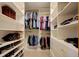 The walk-in closet features built-in shelving, multiple rows for hanging clothes, and space for shoes at 22739 E Prentice Pl, Aurora, CO 80015