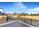 A spacious deck showcases distant treetop views under a bright blue sky at 5731 W 91St Ave, Westminster, CO 80031