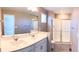 Bathroom featuring double sinks, ample vanity space, and a glass-enclosed shower at 21795 E 8Th Ave, Aurora, CO 80018