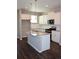 Modern kitchen boasts white cabinets, stainless steel appliances, and a granite island at 21795 E 8Th Ave, Aurora, CO 80018