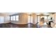 Panoramic view of the living room and kitchen, featuring hardwood floors, windows, and modern appliances at 21795 E 8Th Ave, Aurora, CO 80018