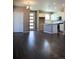 Open-concept living space with hardwood floors, modern lighting, and a view of the kitchen at 21795 E 8Th Ave, Aurora, CO 80018