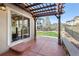 An inviting backyard patio covered by a pergola and featuring stone bench seating and access to a landscaped yard at 2559 S Kendrick St, Lakewood, CO 80228