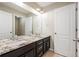 Elegant bathroom featuring a double sink vanity with granite countertop and modern fixtures at 2559 S Kendrick St, Lakewood, CO 80228