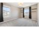 Cozy bedroom with plush carpeting, natural light from two windows, and contemporary shelving at 2559 S Kendrick St, Lakewood, CO 80228