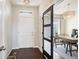 Inviting entryway features dark wood floors, a modern light fixture, and a stylish barn door to the office at 2559 S Kendrick St, Lakewood, CO 80228