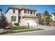 Attractive two-story house with a two-car garage, landscaped front yard, and classic architectural details at 2559 S Kendrick St, Lakewood, CO 80228