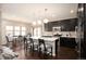 Modern kitchen with dark cabinets, stainless steel appliances, and a large island with bar seating at 2559 S Kendrick St, Lakewood, CO 80228
