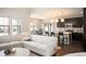 Bright open concept with kitchen view, featuring a white sofa and hardwood floors at 2559 S Kendrick St, Lakewood, CO 80228