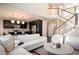 Open living area showcases a modern kitchen with dark cabinets and stylish staircase at 2559 S Kendrick St, Lakewood, CO 80228
