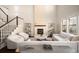 Open-concept living room boasts a floor-to-ceiling fireplace, stairs, and lots of natural light at 2559 S Kendrick St, Lakewood, CO 80228