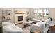 Bright living room featuring a modern fireplace, neutral color palette, and ample seating at 2559 S Kendrick St, Lakewood, CO 80228