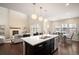 Open-concept living room with fireplace, hardwood floors, and lots of natural light at 2559 S Kendrick St, Lakewood, CO 80228