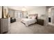 Spacious primary bedroom with neutral tones, carpet, and ensuite bathroom access at 2559 S Kendrick St, Lakewood, CO 80228