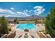 Outdoor pool with gorgeous mountain views and lounge chairs in a beautiful community at 2559 S Kendrick St, Lakewood, CO 80228