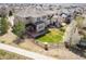 Aerial view of a well-maintained home featuring a manicured lawn and back patio with pergola at 2559 S Kendrick St, Lakewood, CO 80228
