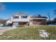 Ranch style home with a brick facade and a spacious lawn at 6740 S Clarkson St, Centennial, CO 80122