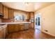 Kitchen with wood cabinets, vinyl flooring, and access to a back patio at 6740 S Clarkson St, Centennial, CO 80122