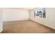 Living room with large window and neutral colored carpet at 6740 S Clarkson St, Centennial, CO 80122