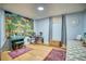 Finished basement area with a decorative wall tapestry, drum set, and a comfortable seating area at 10342 Monterey Cir, Northglenn, CO 80260