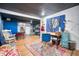 Finished basement with art, seating, desk space, and a vibrant area rug at 10342 Monterey Cir, Northglenn, CO 80260