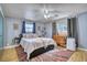 Bright bedroom with two windows, ceiling fan, area rug, and comfortable bed at 10342 Monterey Cir, Northglenn, CO 80260