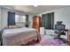 Bedroom with wood floors, a desk, dresser, and comfortable bed at 10342 Monterey Cir, Northglenn, CO 80260