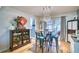 Elegant dining area with hardwood floors, a statement chandelier, and adjacent kitchen view at 10342 Monterey Cir, Northglenn, CO 80260