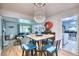 Open dining area with modern chandelier, stylish seating, and hardwood floors at 10342 Monterey Cir, Northglenn, CO 80260
