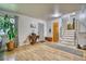 Entryway features hardwood floors, front door, stairs leading to the second floor, and a console table at 10342 Monterey Cir, Northglenn, CO 80260