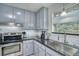 Close-up of a kitchen with stainless steel appliances, tile backsplash, and modern fixtures at 10342 Monterey Cir, Northglenn, CO 80260