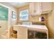 Functional laundry room with a washer, dryer, sink, and ample storage space at 10342 Monterey Cir, Northglenn, CO 80260