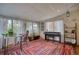 Bright sunroom features an electric piano, seating, and ample natural light at 10342 Monterey Cir, Northglenn, CO 80260