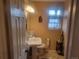 Bright bathroom features modern fixtures, pedestal sink, updated lighting, and a neutral color palette at 2190 S Holly St # 213, Denver, CO 80222