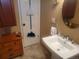 Bathroom with pedestal sink, tile flooring, and a classic design, providing a clean and functional space at 2190 S Holly St # 213, Denver, CO 80222