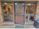 Inviting front entrance featuring a secure metal screen door and large windows bringing natural light at 2190 S Holly St # 213, Denver, CO 80222