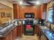 Updated kitchen boasts granite countertops, tile backsplash, stainless steel sink, and modern appliances at 2190 S Holly St # 213, Denver, CO 80222