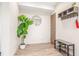 An organized entryway with a plant, hooks, and shoe storage for a welcoming first impression at 1318 Yates St, Denver, CO 80204