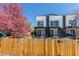 View of the contemporary townhome showcasing modern architecture and a privacy fence at 1318 Yates St, Denver, CO 80204