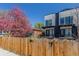 View of new townhomes with manicured yards and wood fence adding to the property's curb appeal at 1318 Yates St, Denver, CO 80204